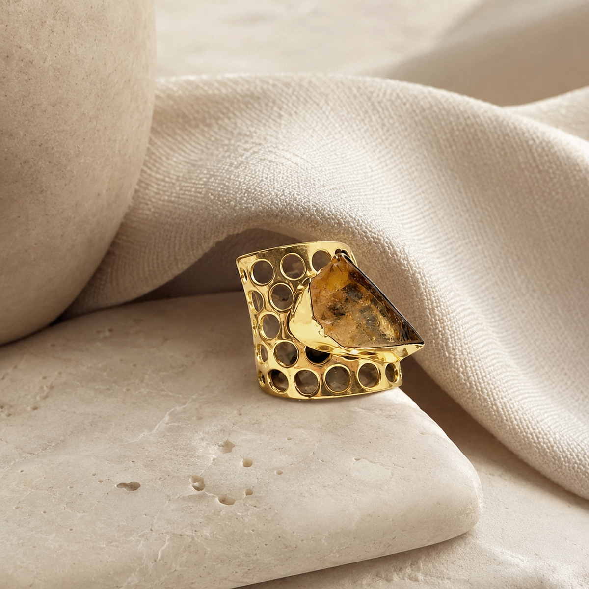 Gold-plated ring with open circular details and a rough citrine center.