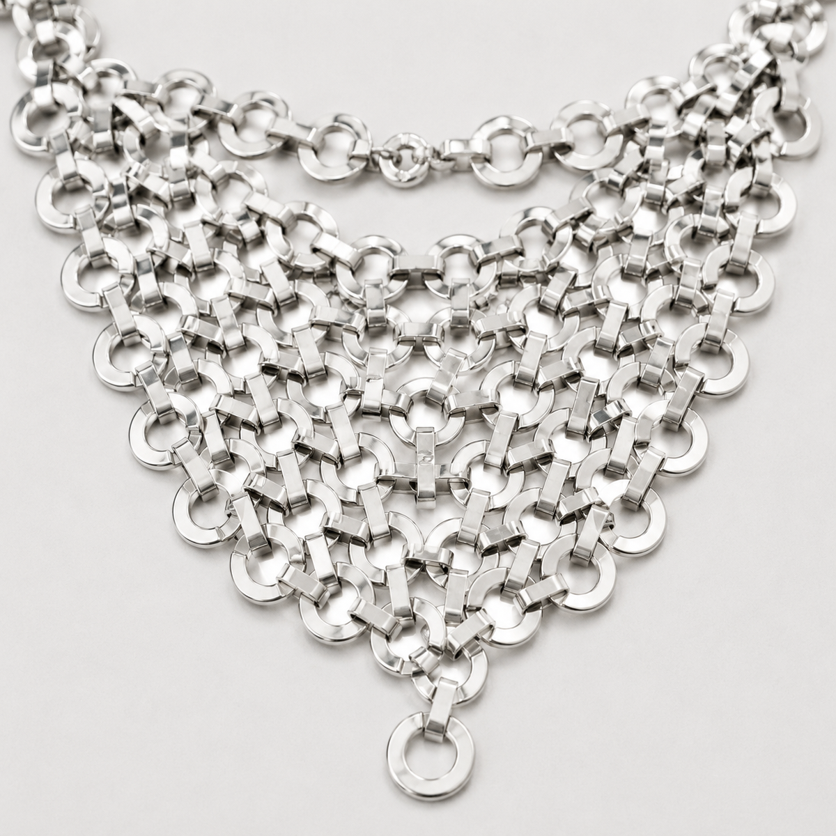 Close view of the linked circle mesh detail in silver tone.