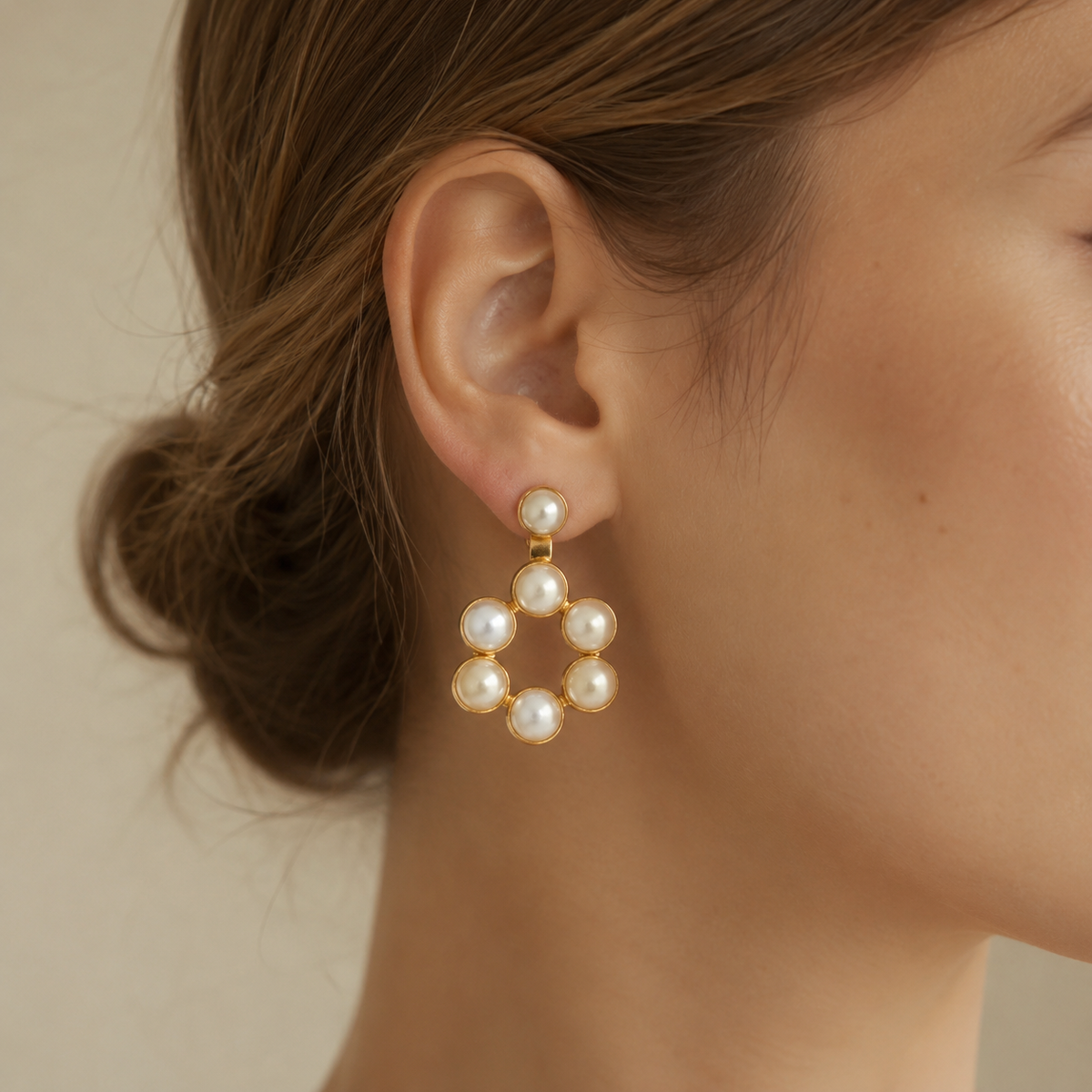 Pair of gold-plated hoop drop earrings with pearl-inspired details.