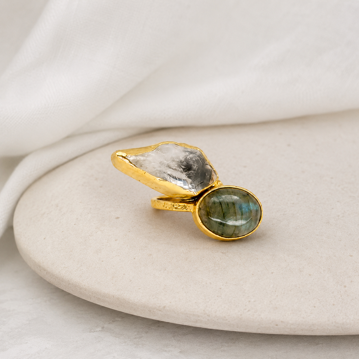 Gold-plated ring with a sculptural two-stone design.