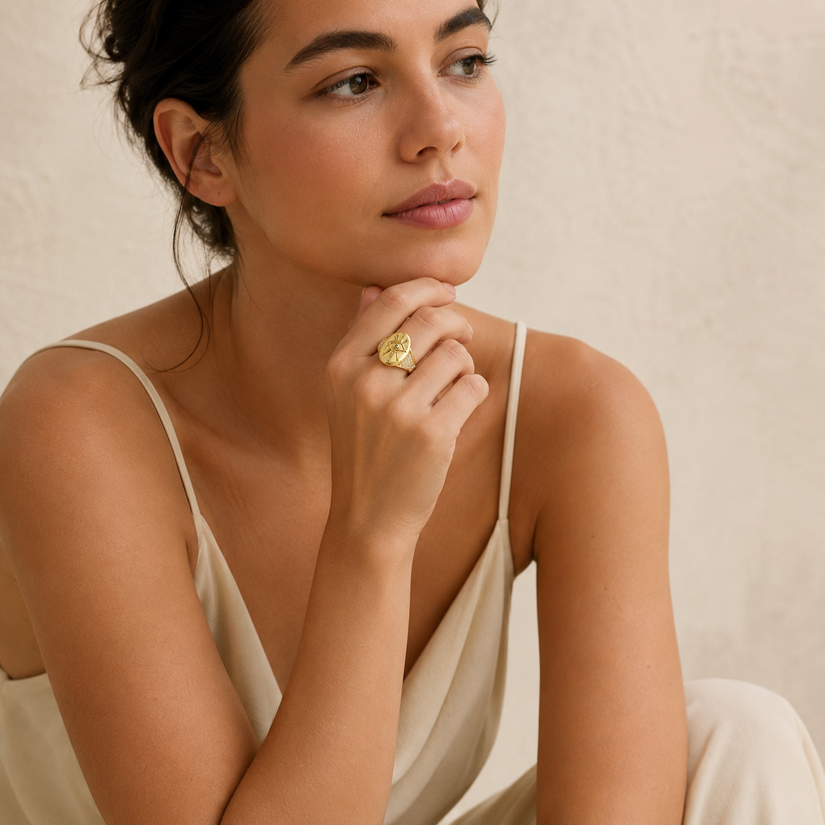 Gold-tone evil eye ring with a bold, modern silhouette.