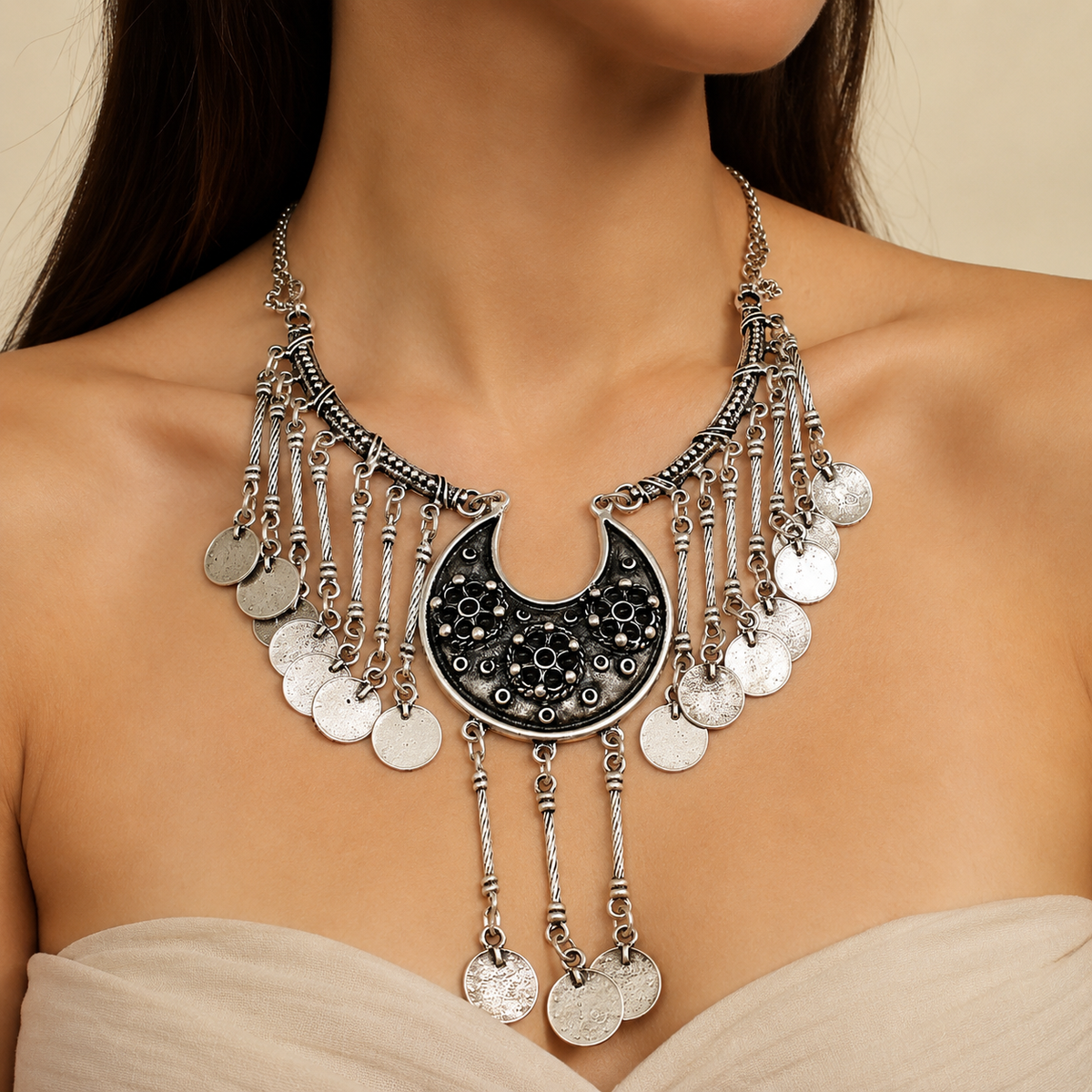 Silver-tone pendant necklace with black bead detail and chain fringe.