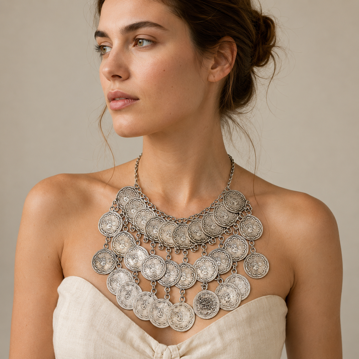 Statement coin necklace with a layered silver-tone design.