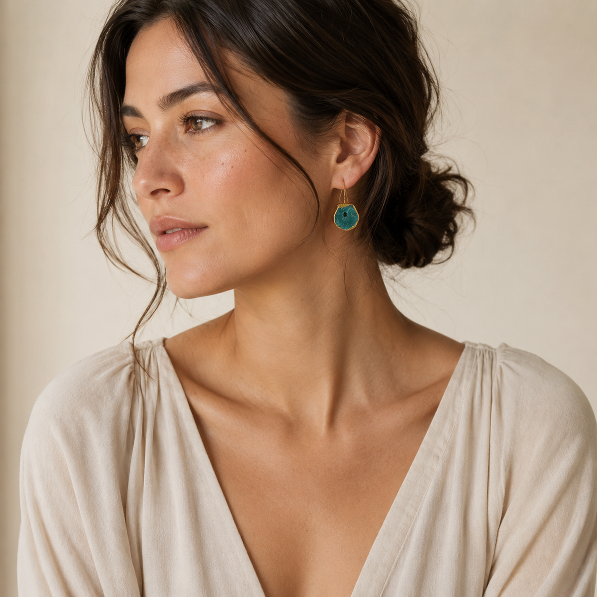 Gold-plated drop earrings with brown druzy mother of pearl centers and long ear wires.