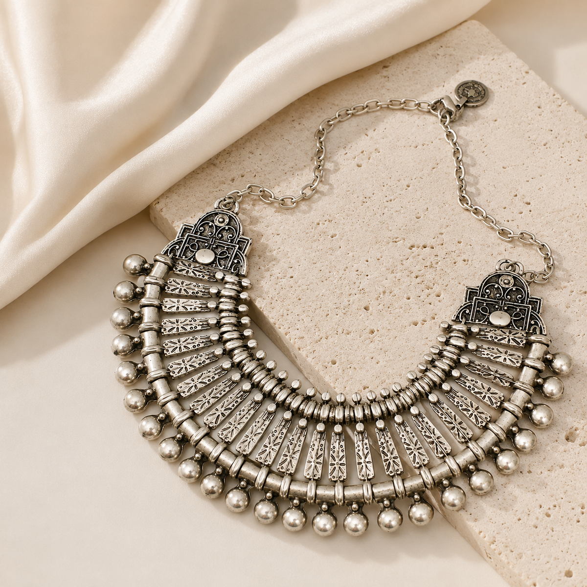 Silver-tone boho collar necklace with a wide fan shape and decorative fringe elements.