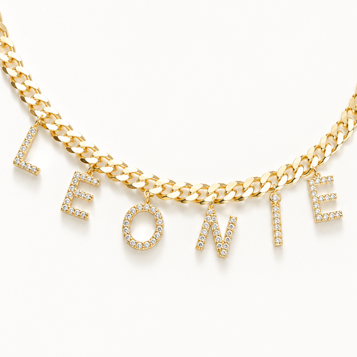 Close view of CZ letter charms on a gold-tone chain.