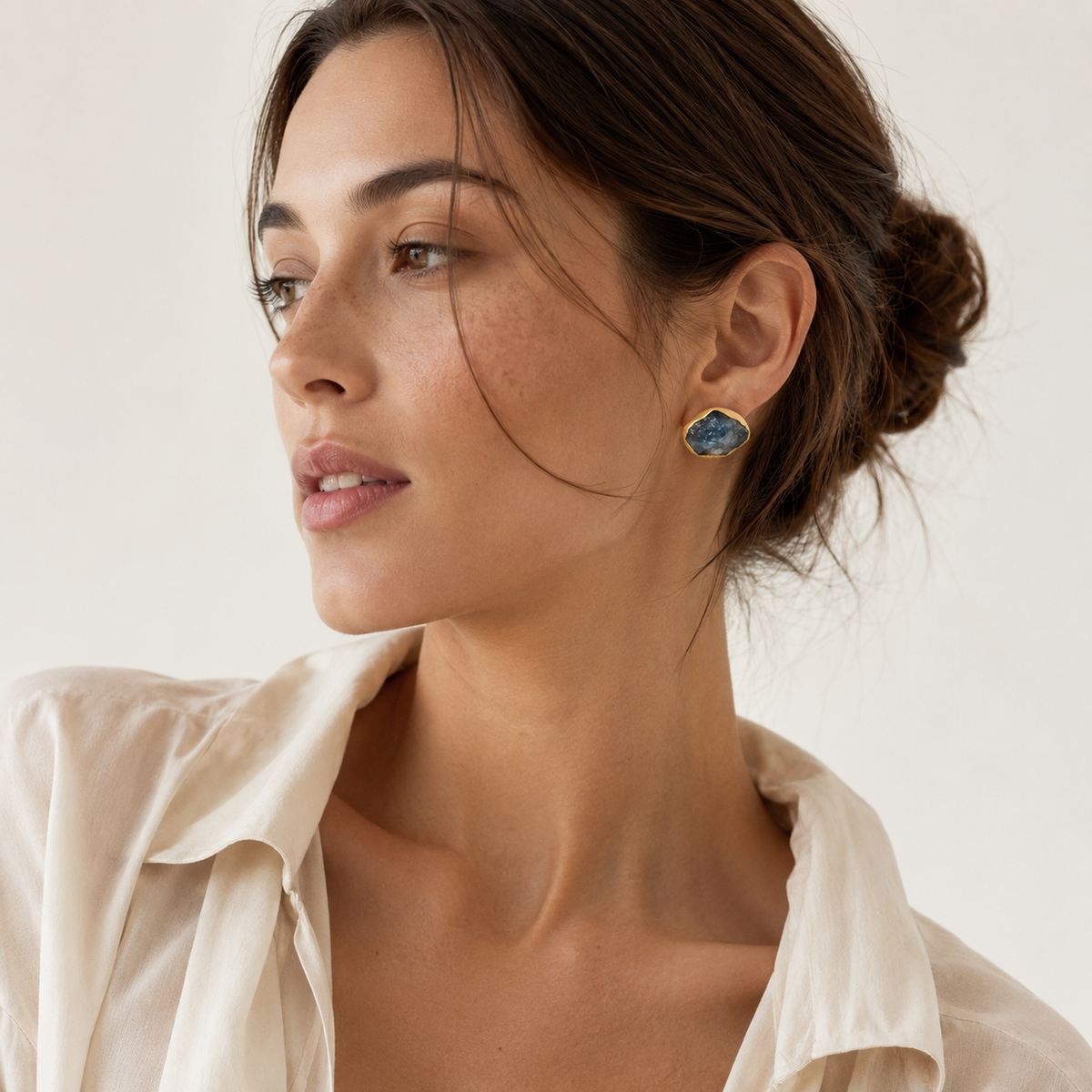 Gold-plated heart stud earrings with a polished finish and crystal detail.