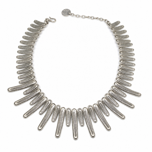 Silver-tone collar necklace with a wave-inspired bar design.