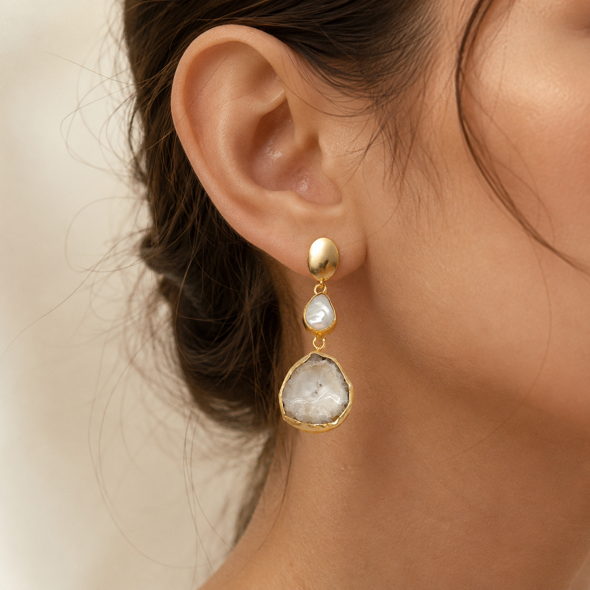 Gold-plated drop earrings with baroque pearl-inspired centers and organic stone-like pendants.