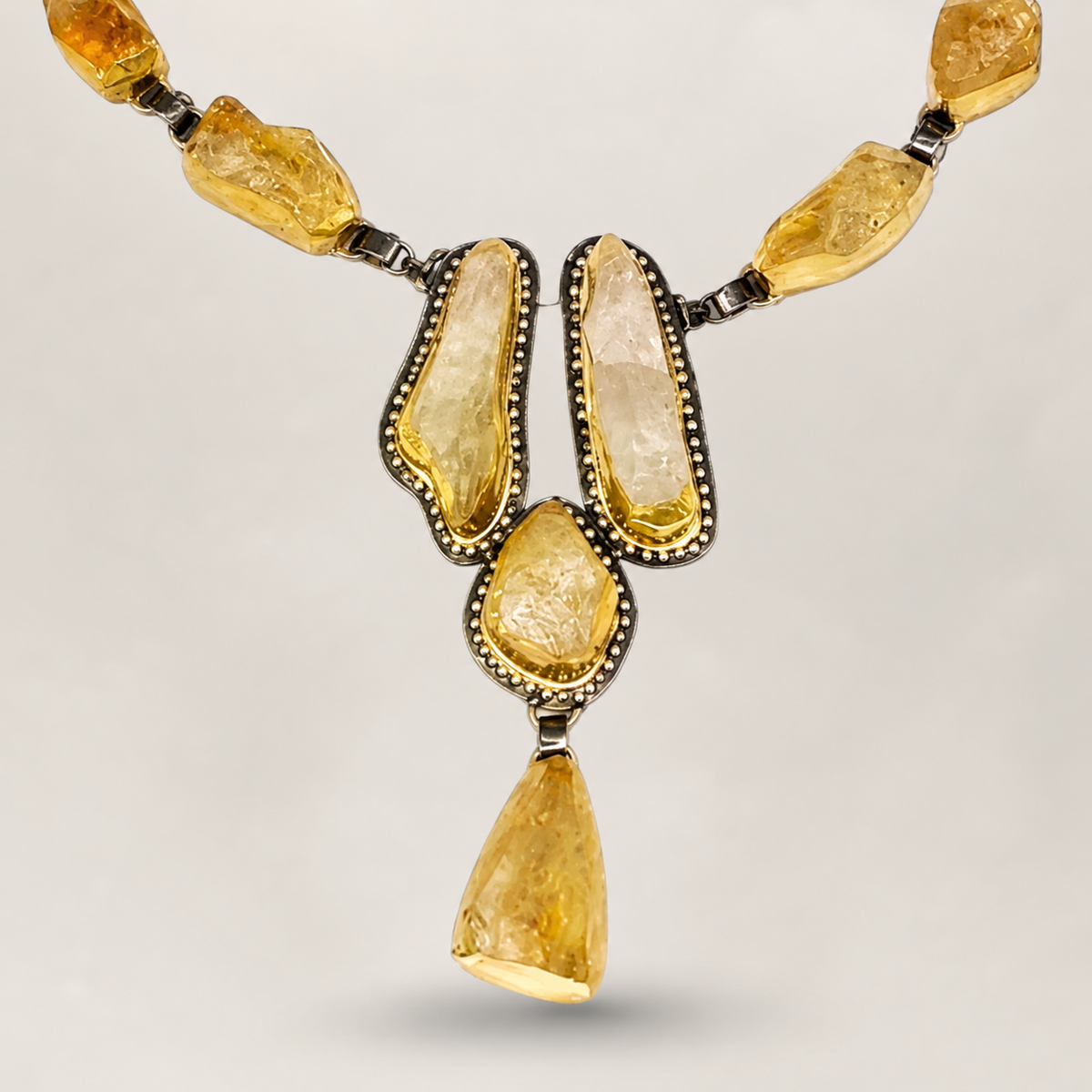Close view of the raw citrine stone details and gold-tone settings.