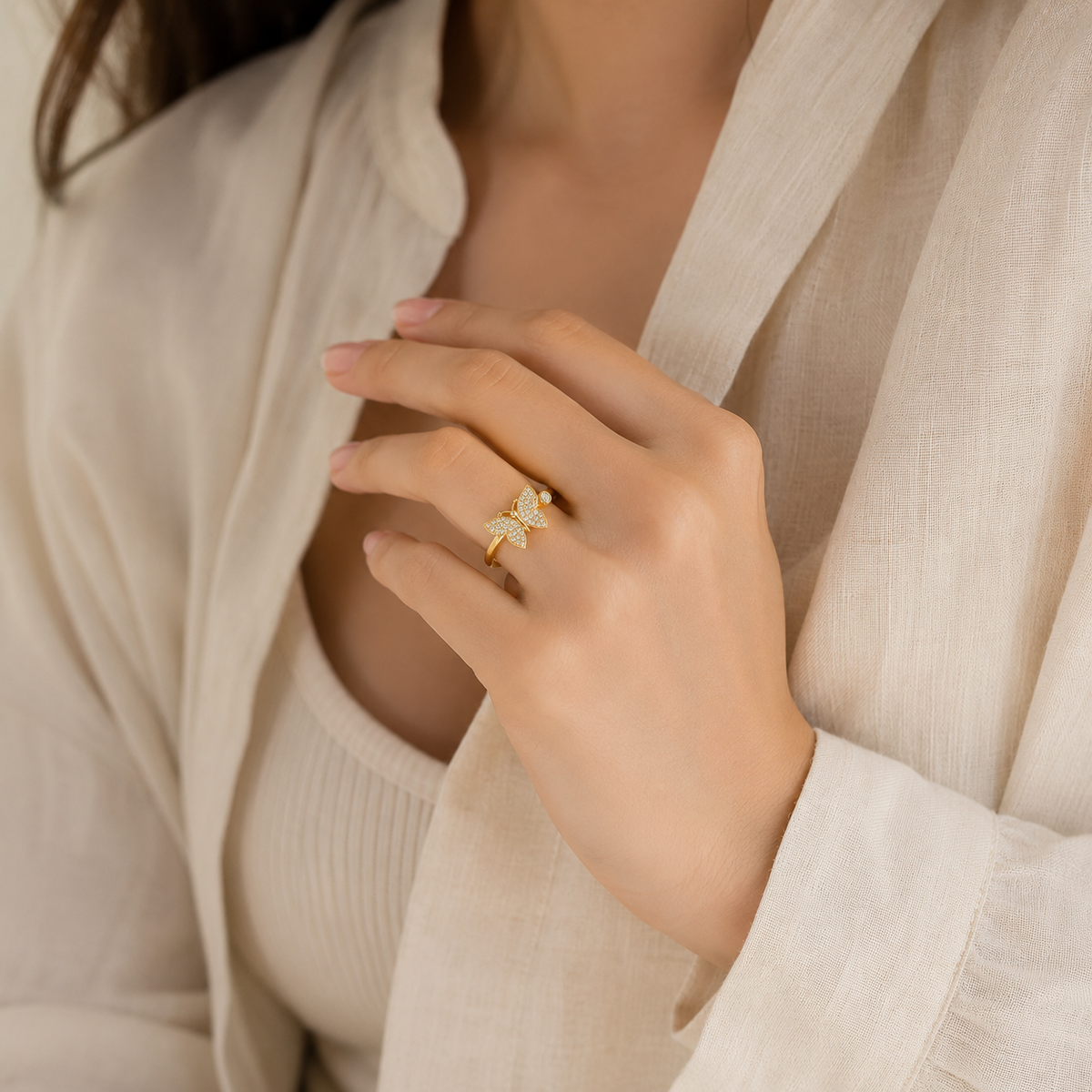 Gold butterfly ring with CZ accents and a bright polished finish.