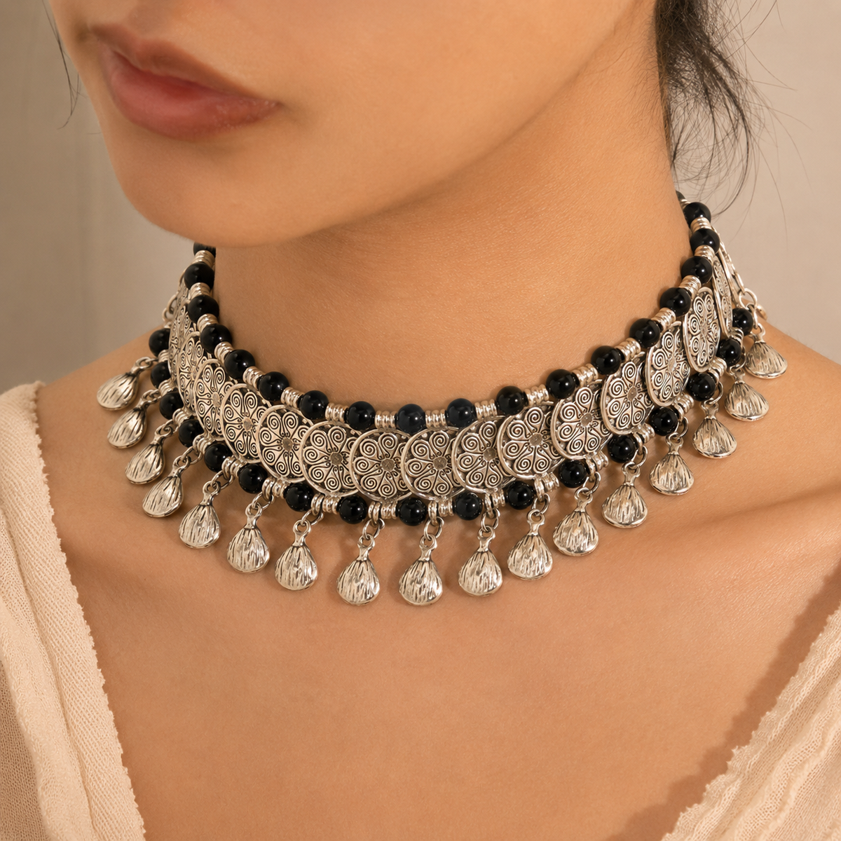 Black bead choker necklace shown in a front view with ornate coin details.