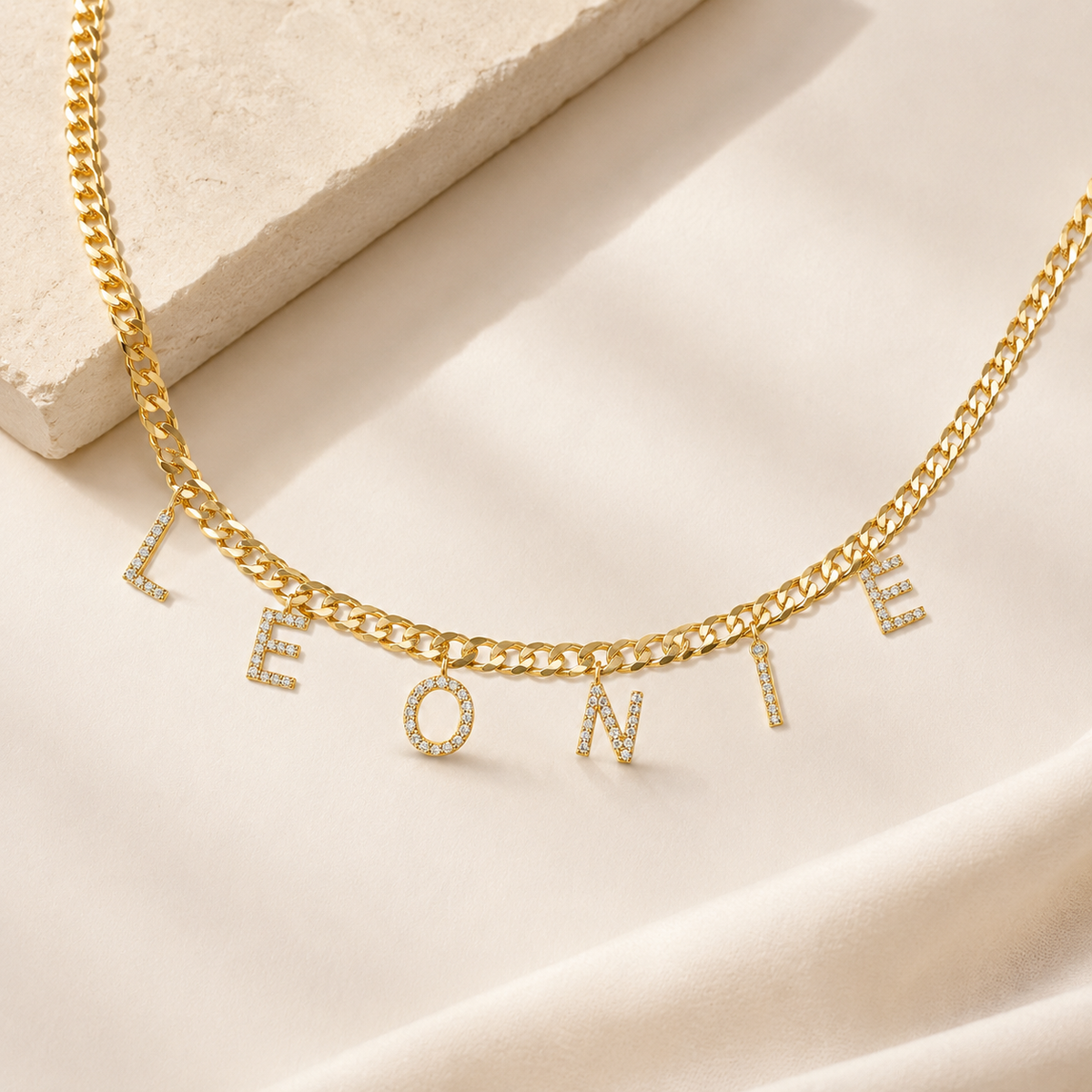Personalized letter necklace with a gold-tone chain and CZ accents.