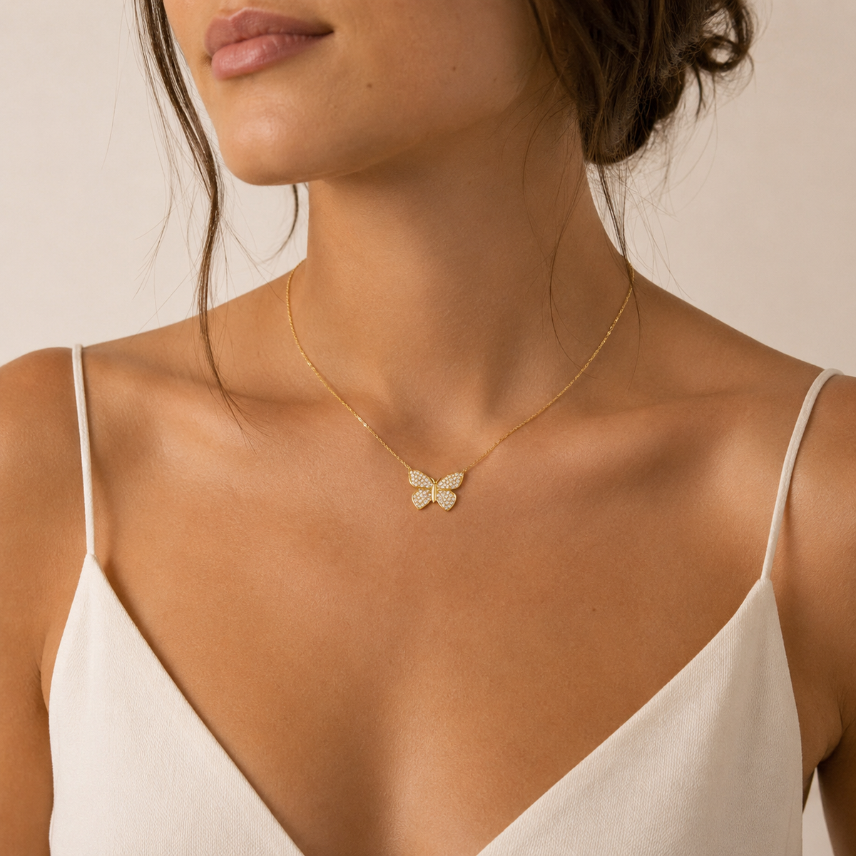 Gold-tone butterfly necklace with a soft feminine silhouette.