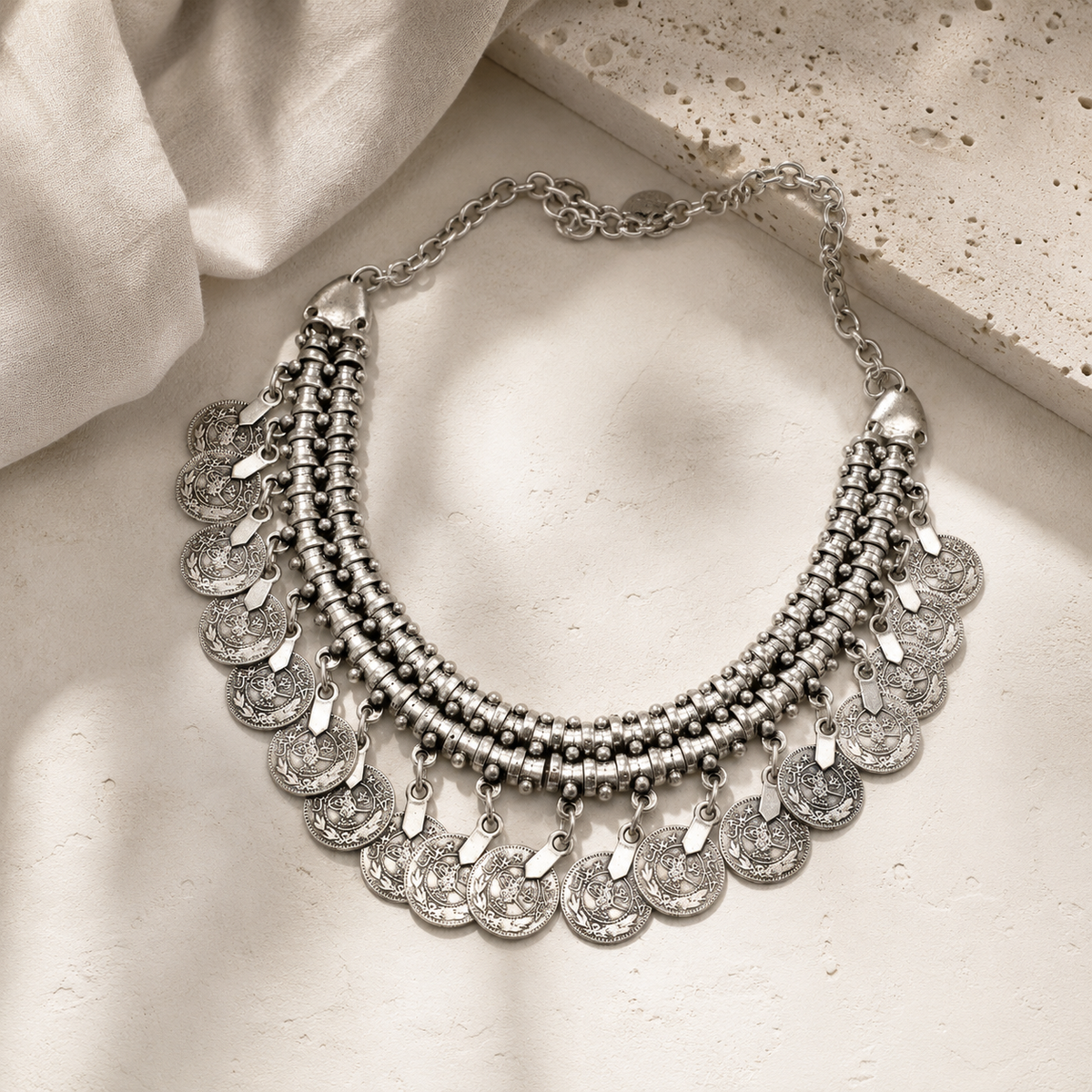 Silver-tone fringe collar necklace with a bold layered silhouette.