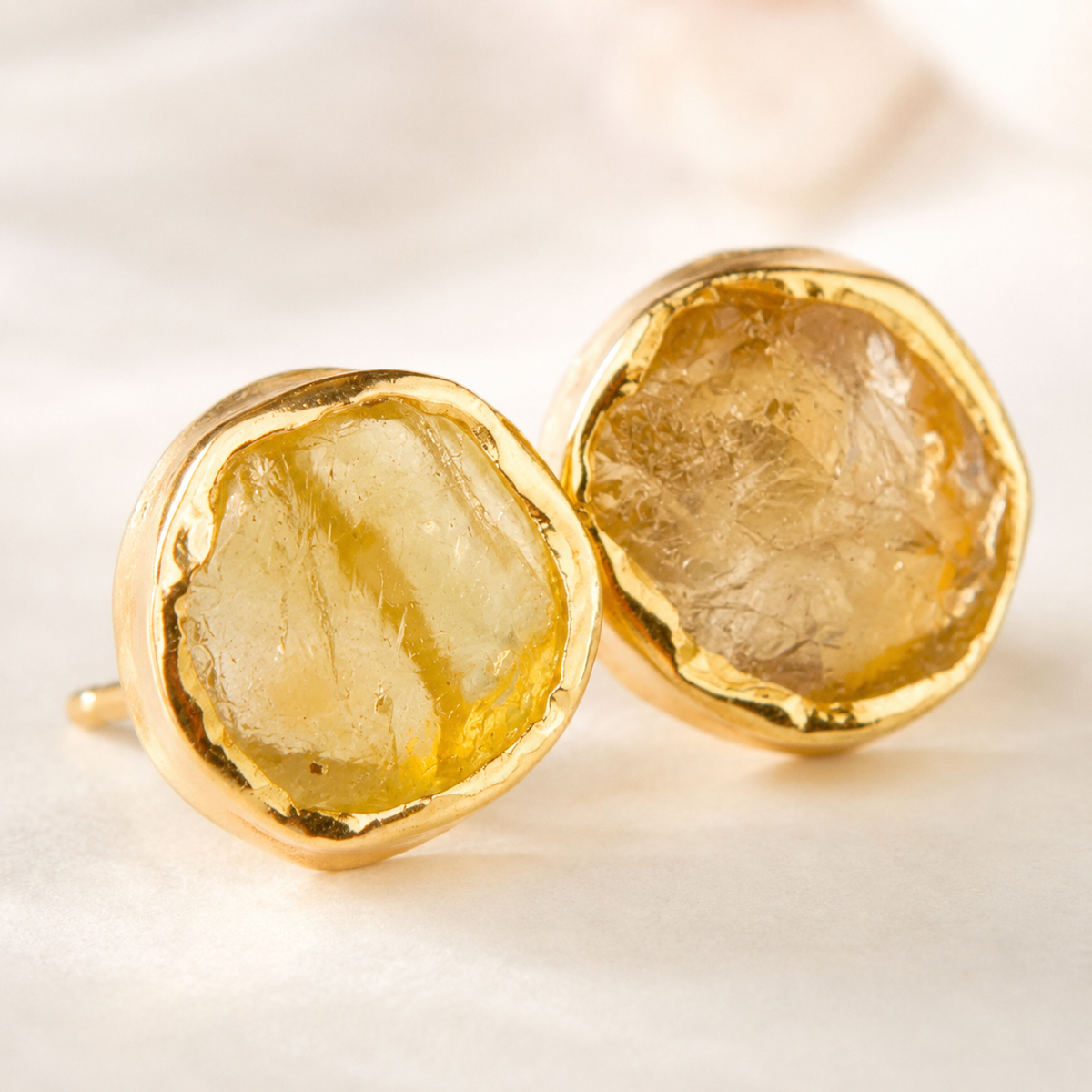 Close-up view of rough citrine stones in a gold setting.