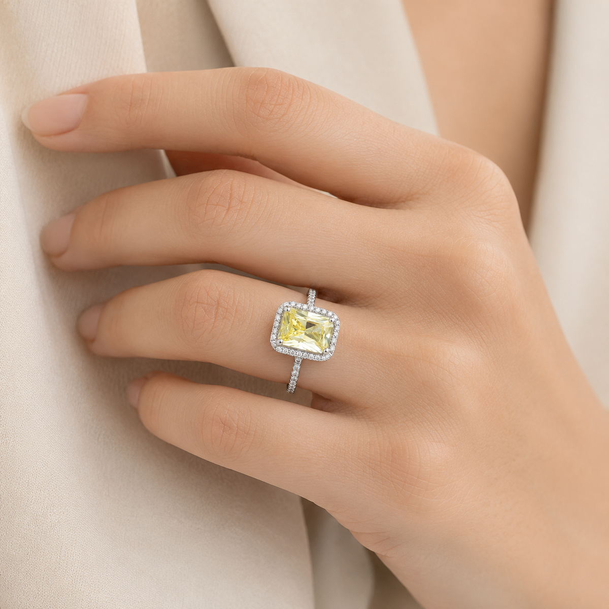 A close view of the canary yellow rectangular stone and silver-tone band.