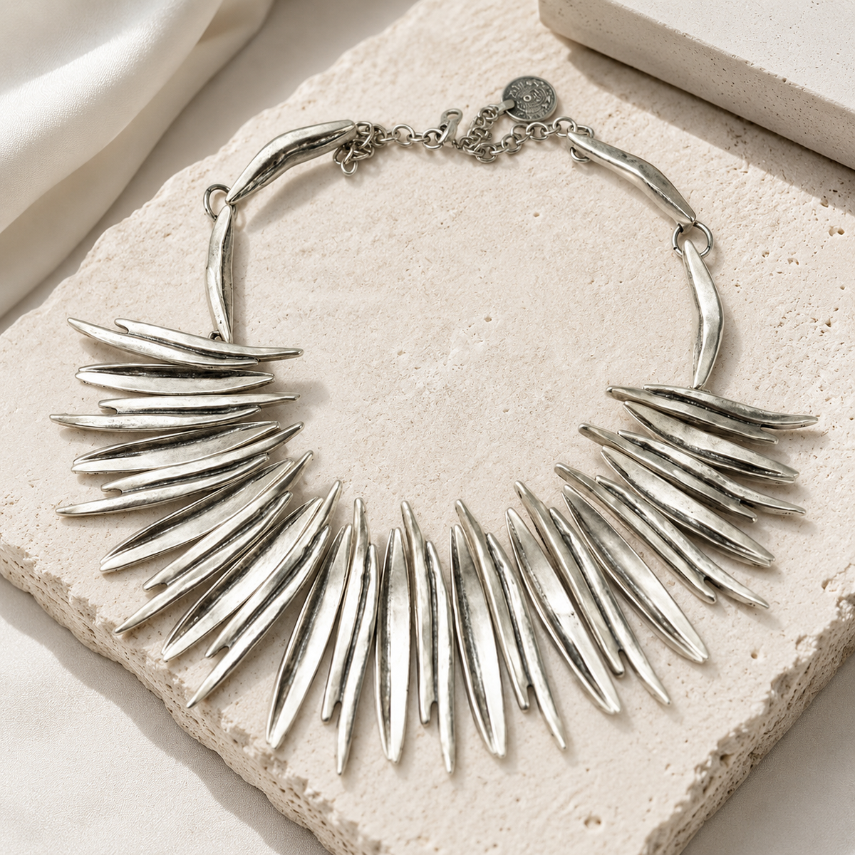 Silver-tone collar necklace with long pointed spikes and a bold silhouette.