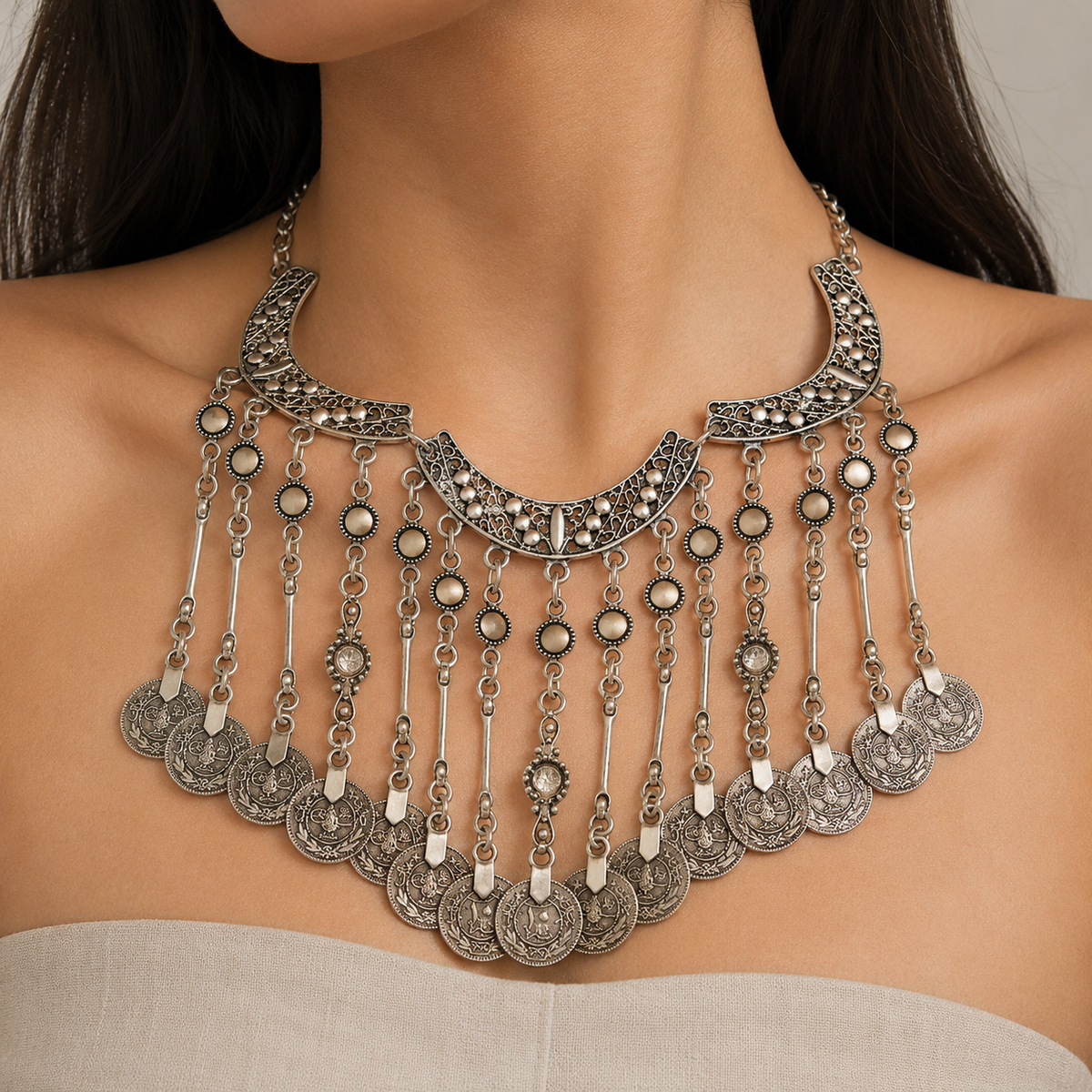 Silver-tone crescent statement necklace with dangling coin fringe.