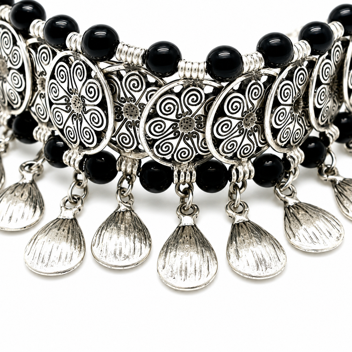 Close view of black beads and filigree coin charms on the choker necklace.
