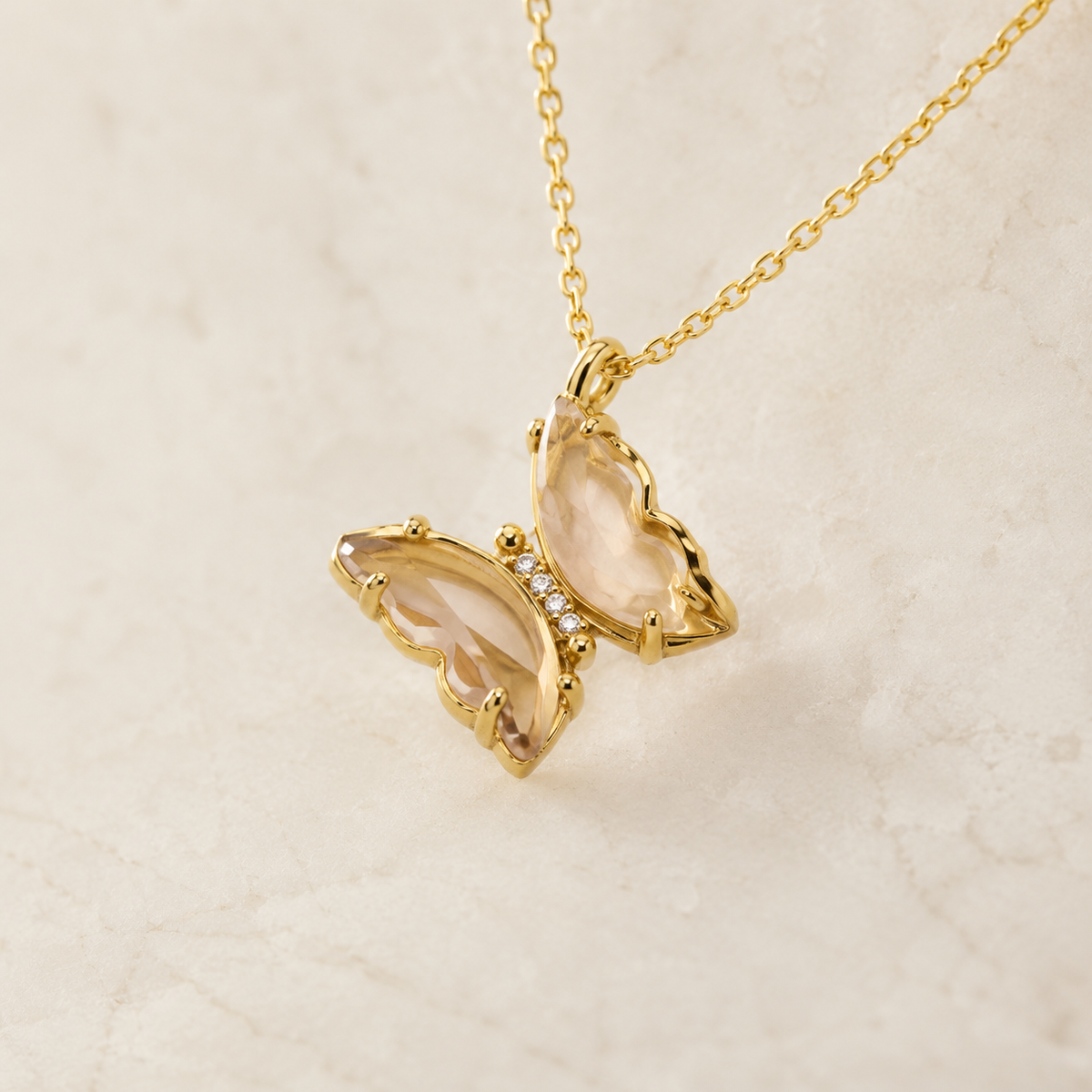 Close view of the butterfly pendant with crystal sparkle and gold finish.