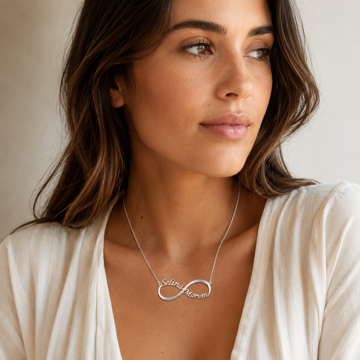Personalized engraved infinity necklace shown in a clean studio view.