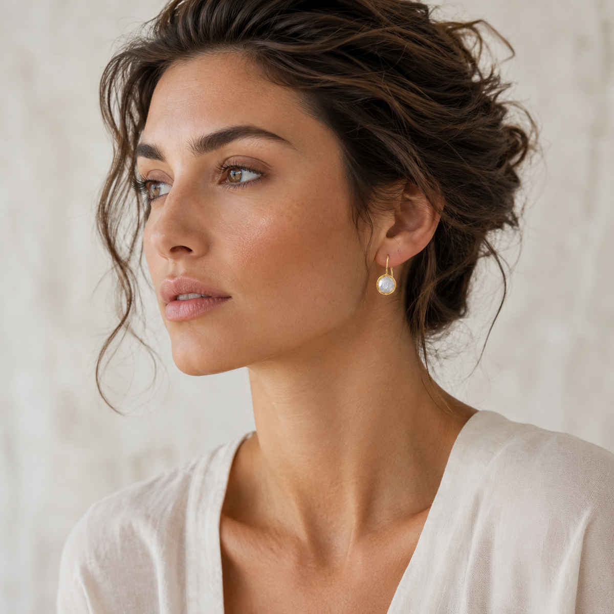 Round clear CZ gold-plated drop earrings shown from the front.