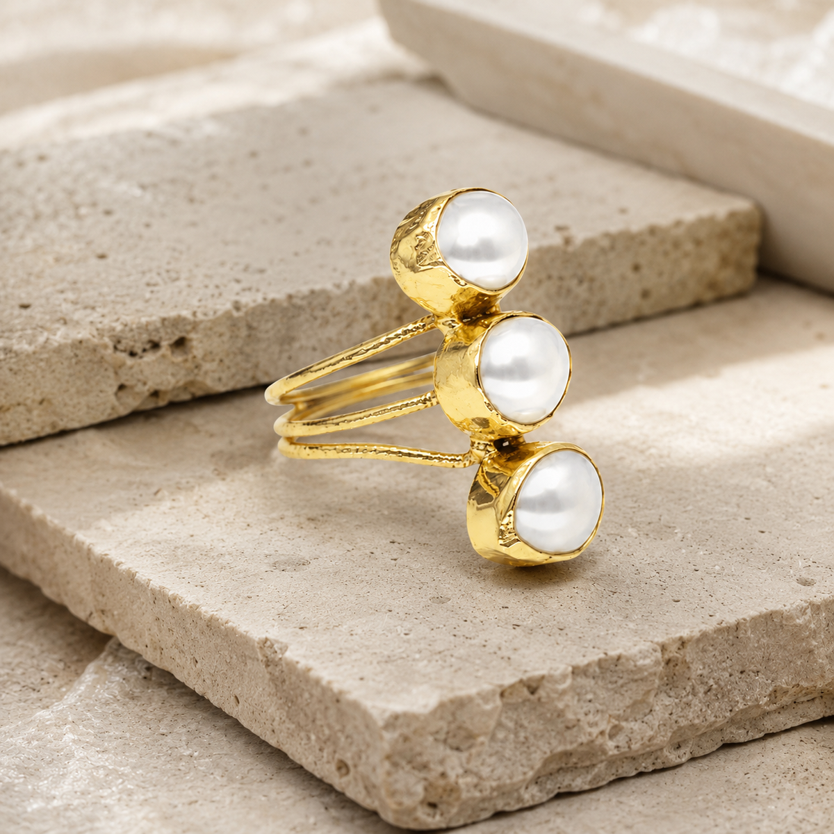 Side angle view of the triple pearl open wrap ring.