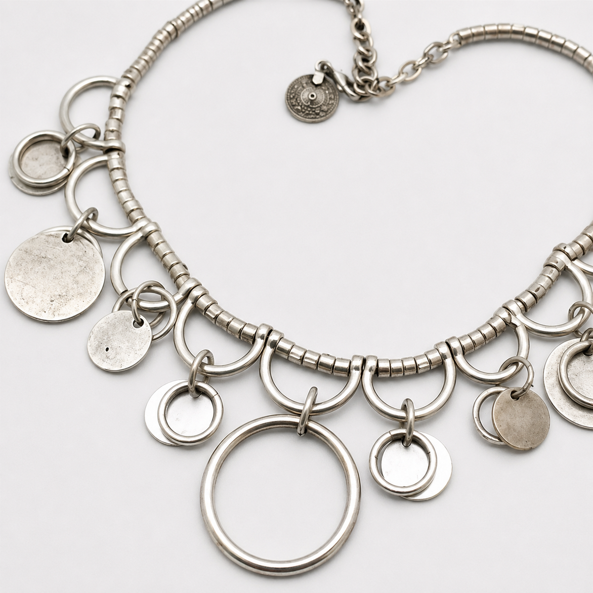 Close view of the silver-tone ring charm details.