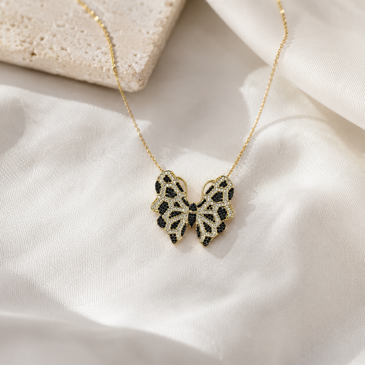 Butterfly pendant necklace styled on a delicate gold-tone chain.