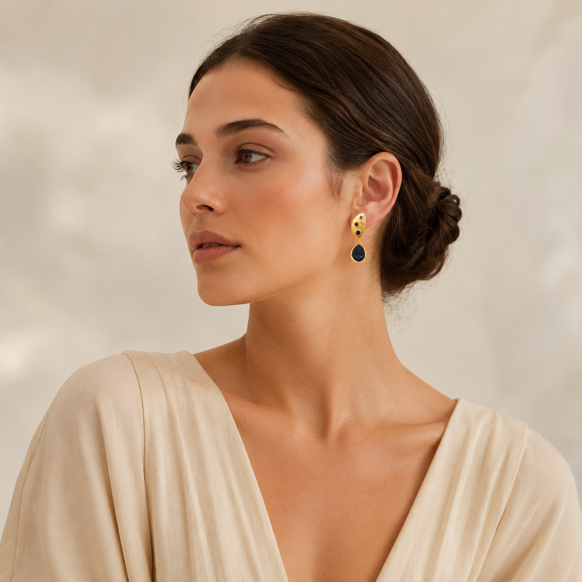 Gold plated half moon earrings with dark stone drops.