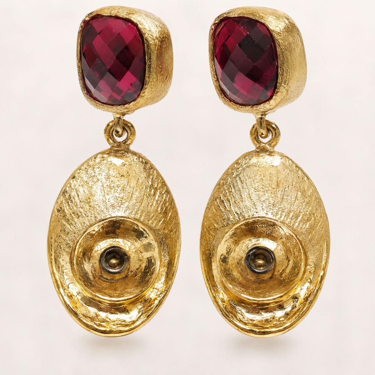 Close view of olive green stone and textured gold-plated detail.