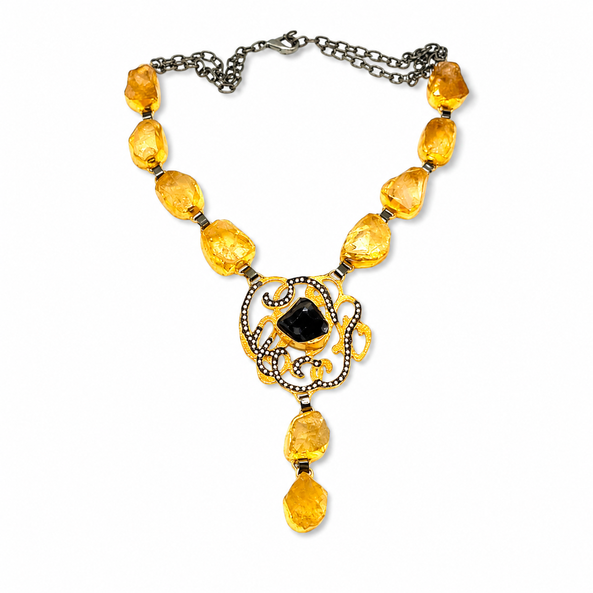 Citrine medallion drop necklace with gold-tone stones and an ornate pendant.