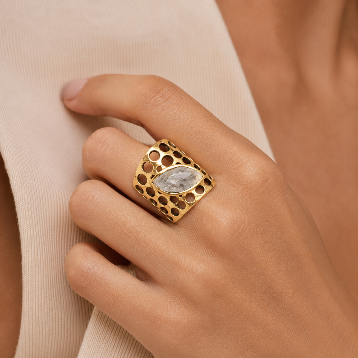Gold-plated ring with clear quartz and a bold openwork honeycomb setting.