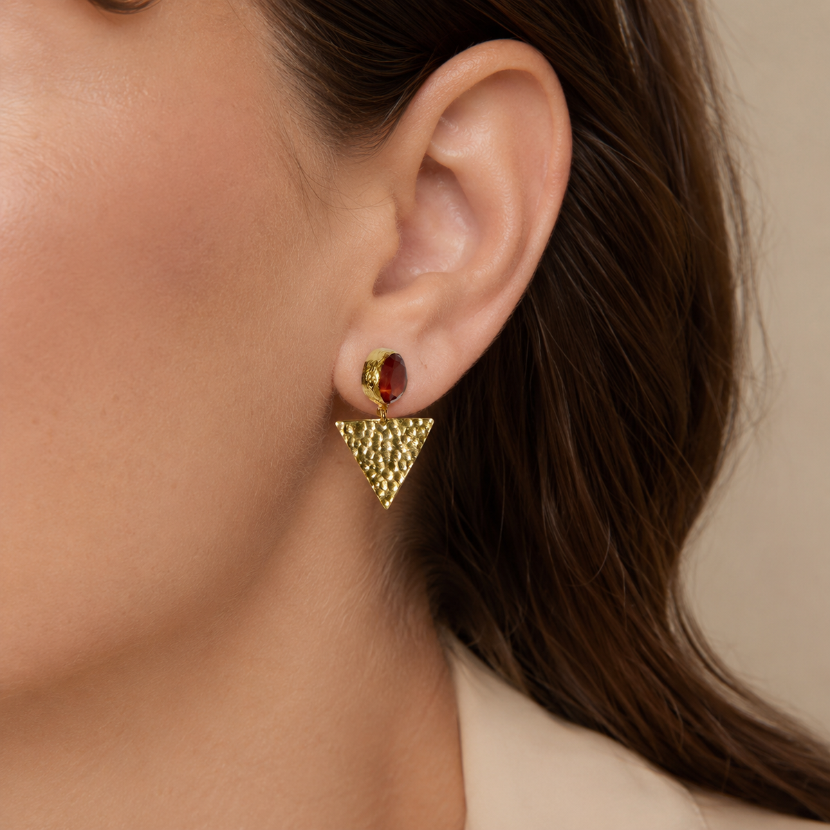 Orange triangle gold plated drop earrings shown front view on a white background.