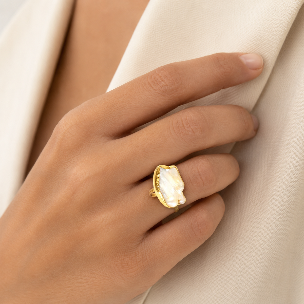 Mother of pearl baroque ring shown from the front on a white background.