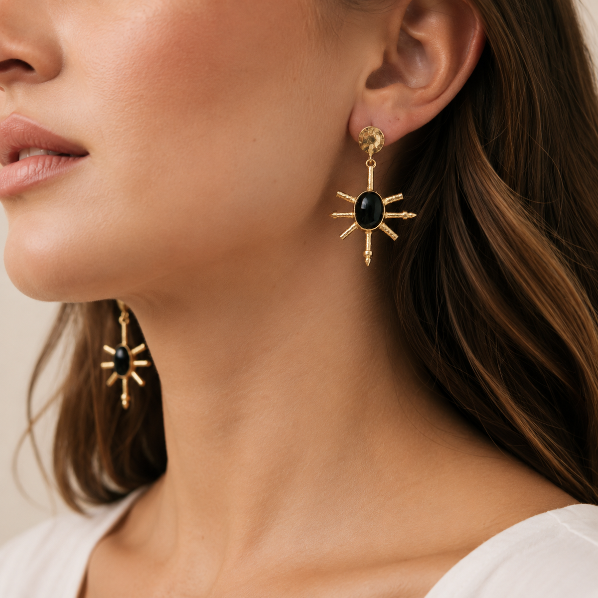 Gold-plated statement earrings with black onyx centers and spike details.