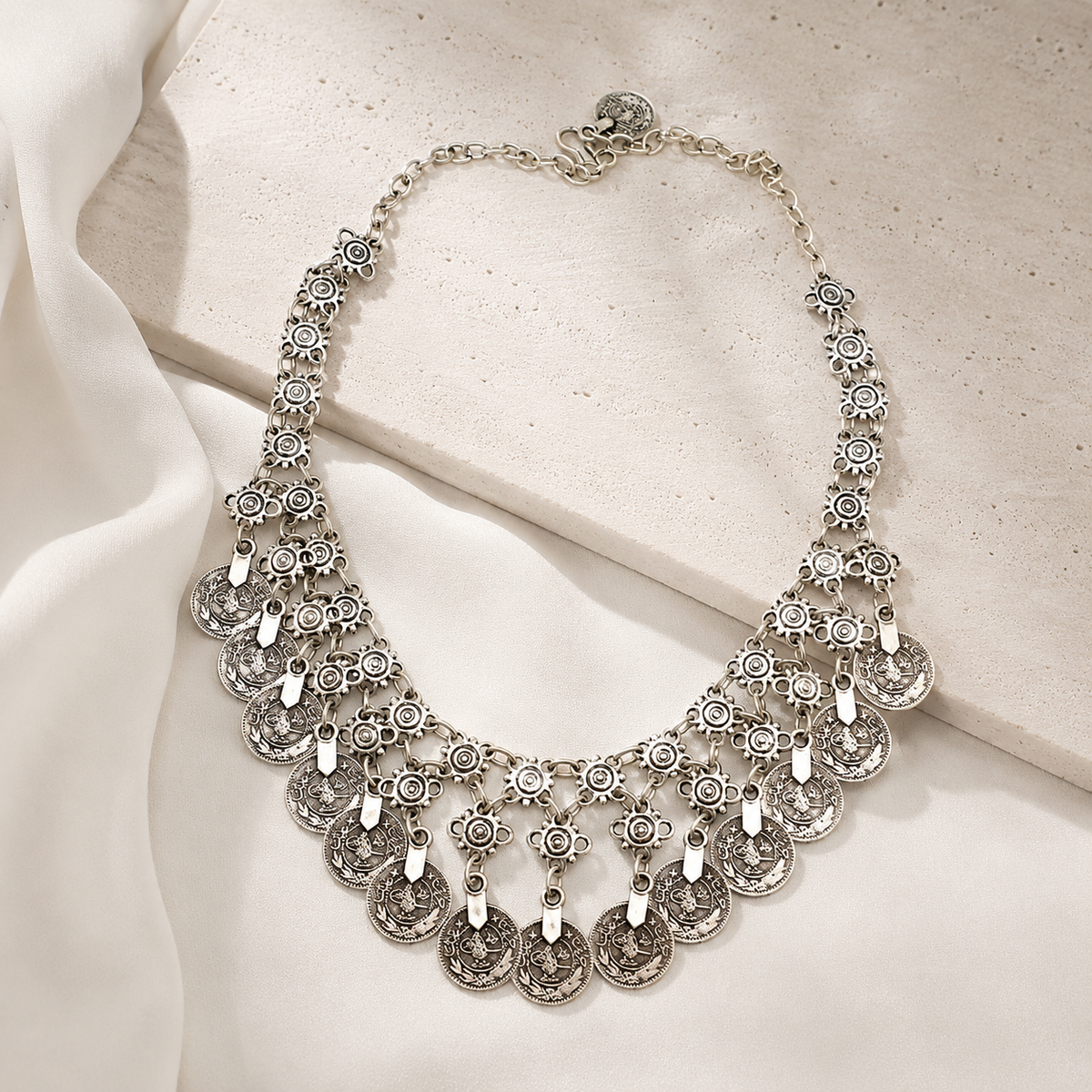 Silver-tone statement necklace with layered fringe styling.