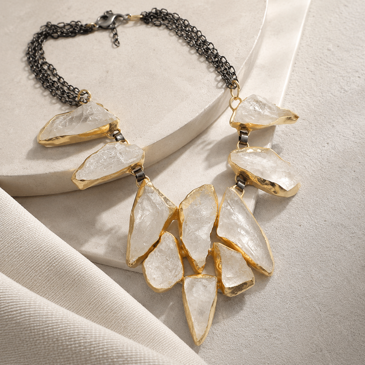 Angled view of the rock crystal statement necklace with black chain and gold-tone accents.