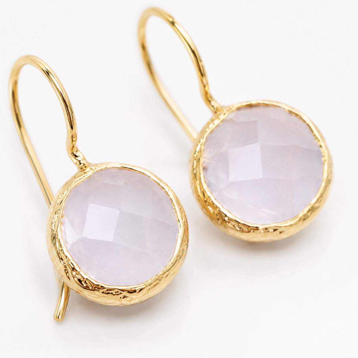 Close view of moonstone and gold-plated detailing on the earrings.