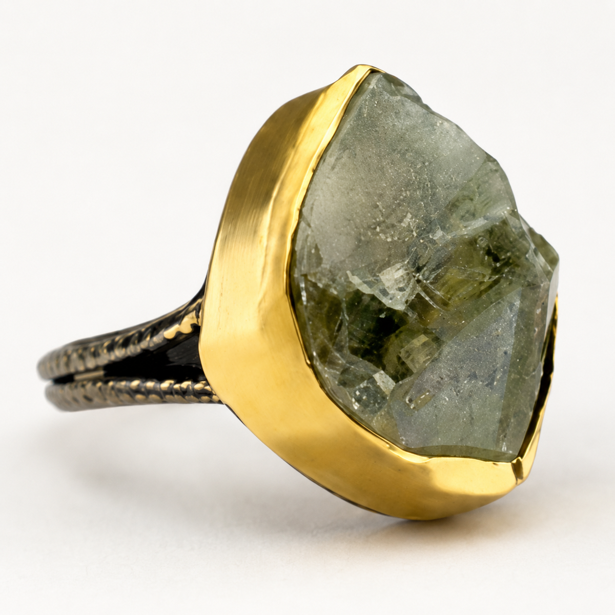 Close view of the raw green amethyst stone and gold-plated ring setting.