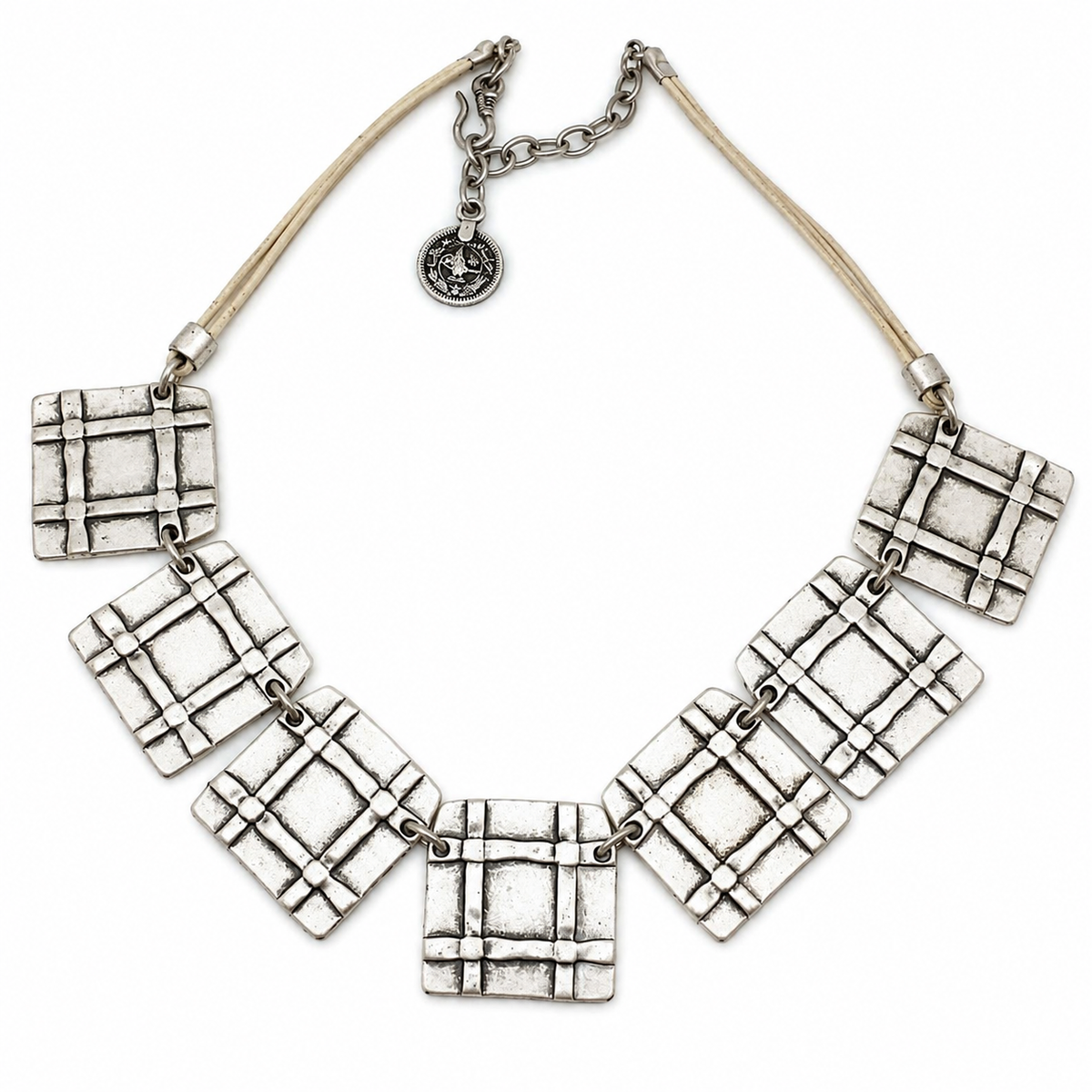 Beige cord necklace with linked square grid pendants in a graphic design.