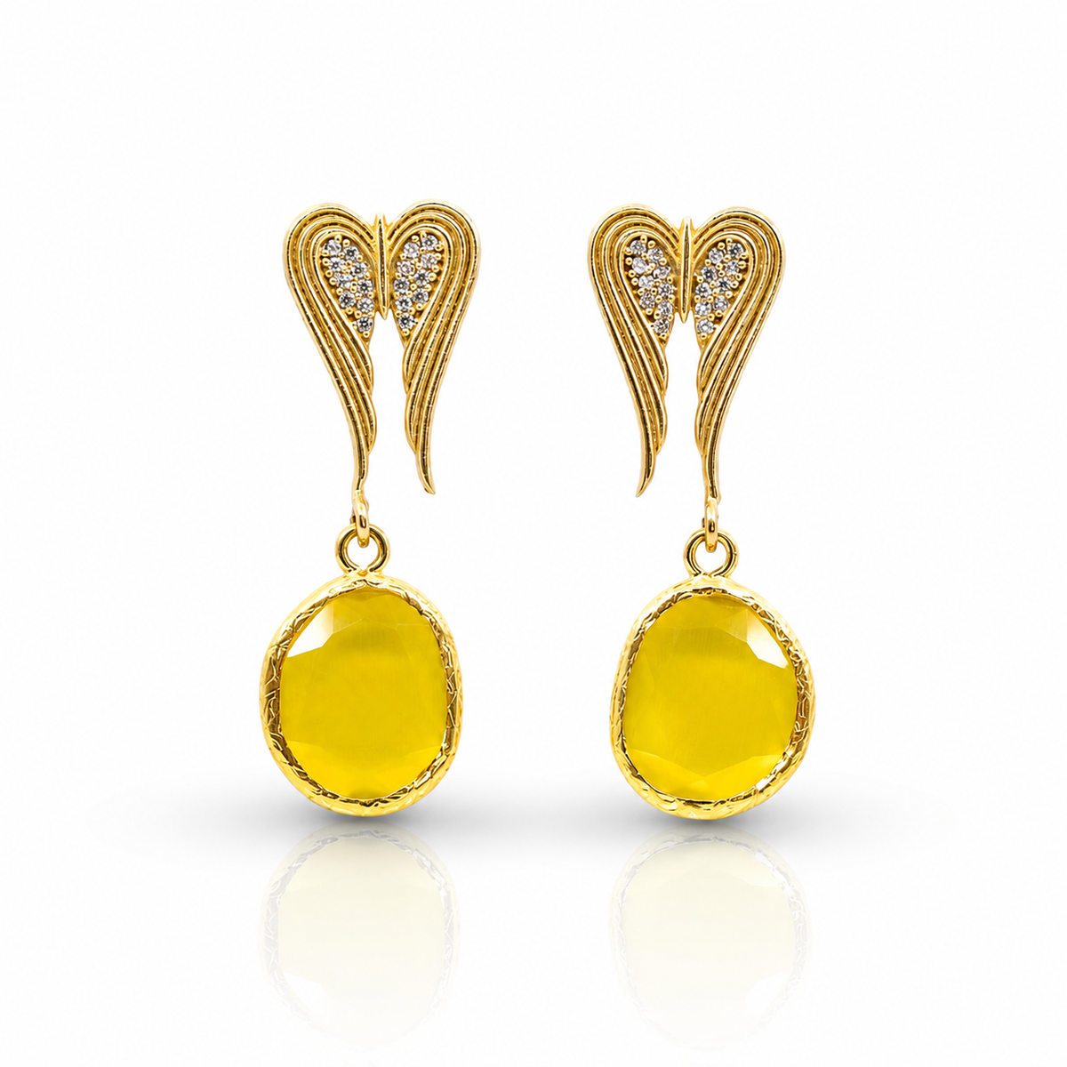 Gold-tone heart-shaped dangle earrings with black crystal detail.