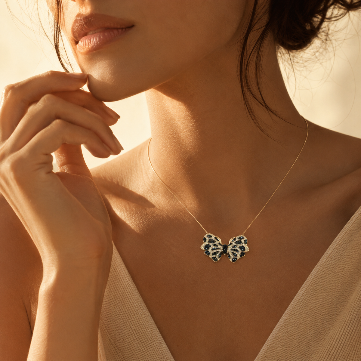 Gold-tone necklace with a butterfly-shaped pendant in black and turquoise-inspired tones.