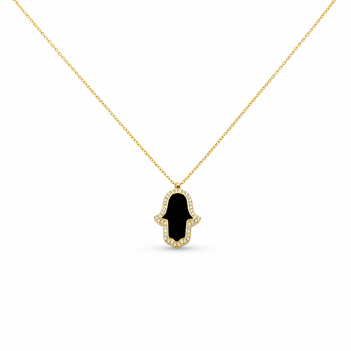 Gold-tone necklace with a black enamel hamsa hand pendant and CZ outline.
