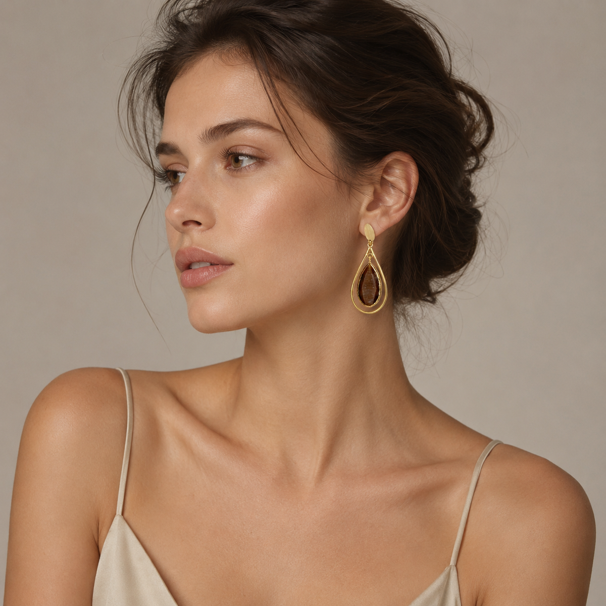 Brown teardrop drop earrings with a gold-plated cage silhouette.