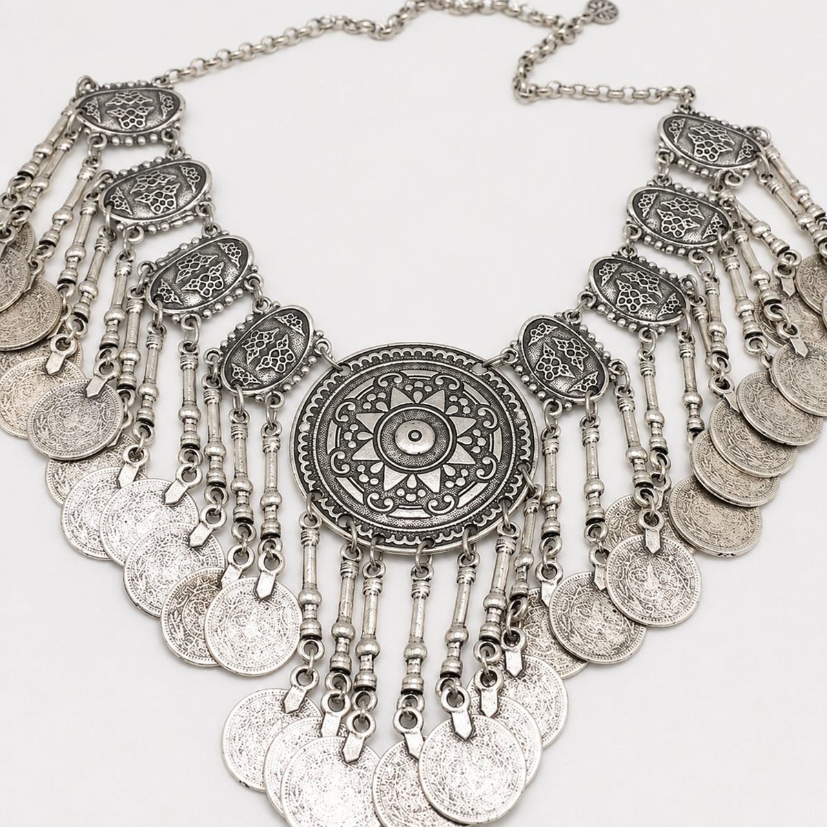 Silver-tone statement necklace shown from above on a white background.