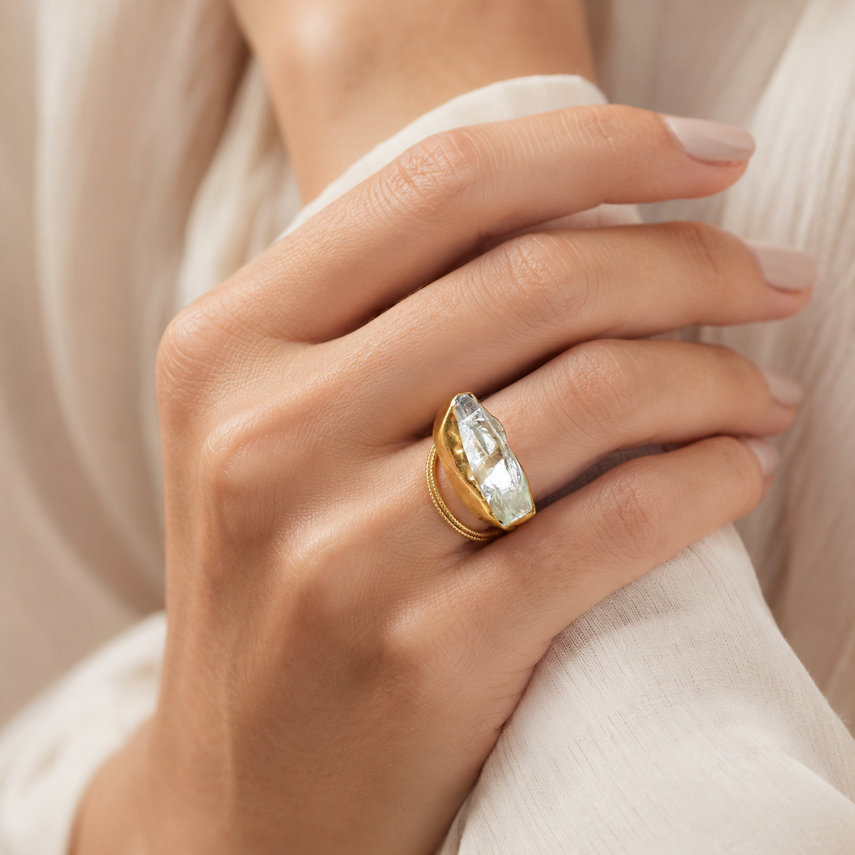 Raw crystal quartz statement ring shown at an angle with a gold-plated band.