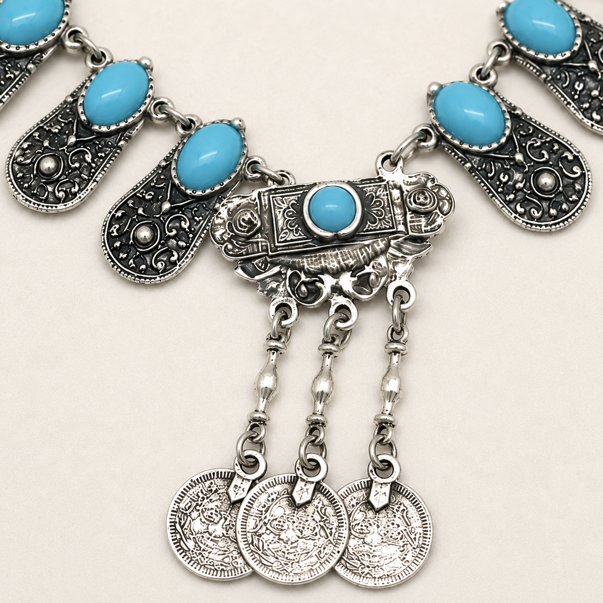 Close view of the engraved silver-toned panels and blue oval details.