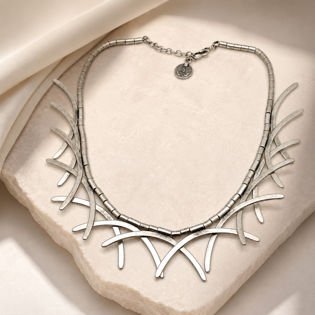 Silver-tone abstract branch collar necklace with a modern organic shape.